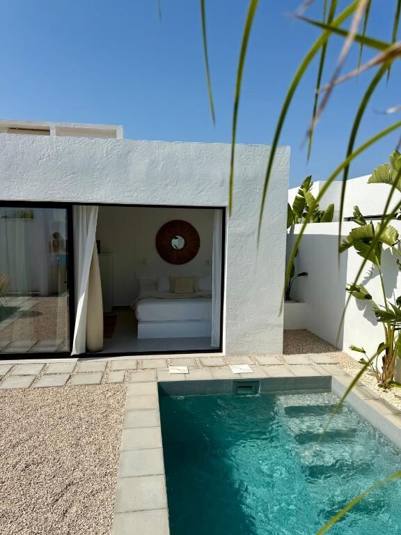 Guest room opening onto a private plunge pool at EBLI7 Hotel Boutique