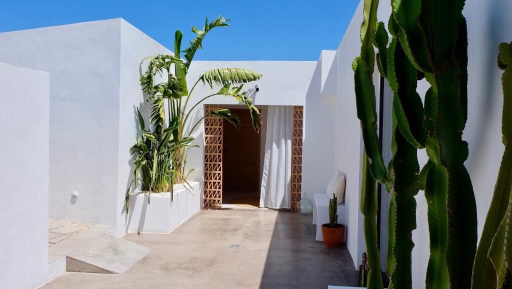 White courtyard architecture and greenery at EBLI7 Hotel Boutique in Orihuela Costa